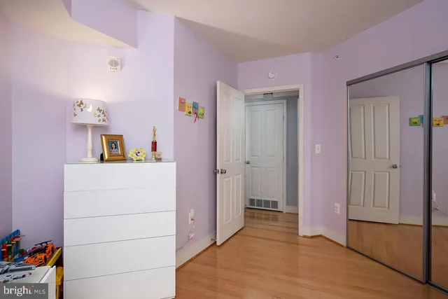 a hallway with cabinet and wooden floor