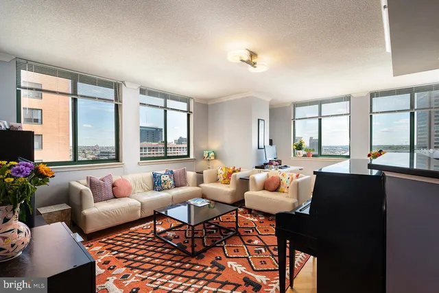 a living room with furniture and a large window