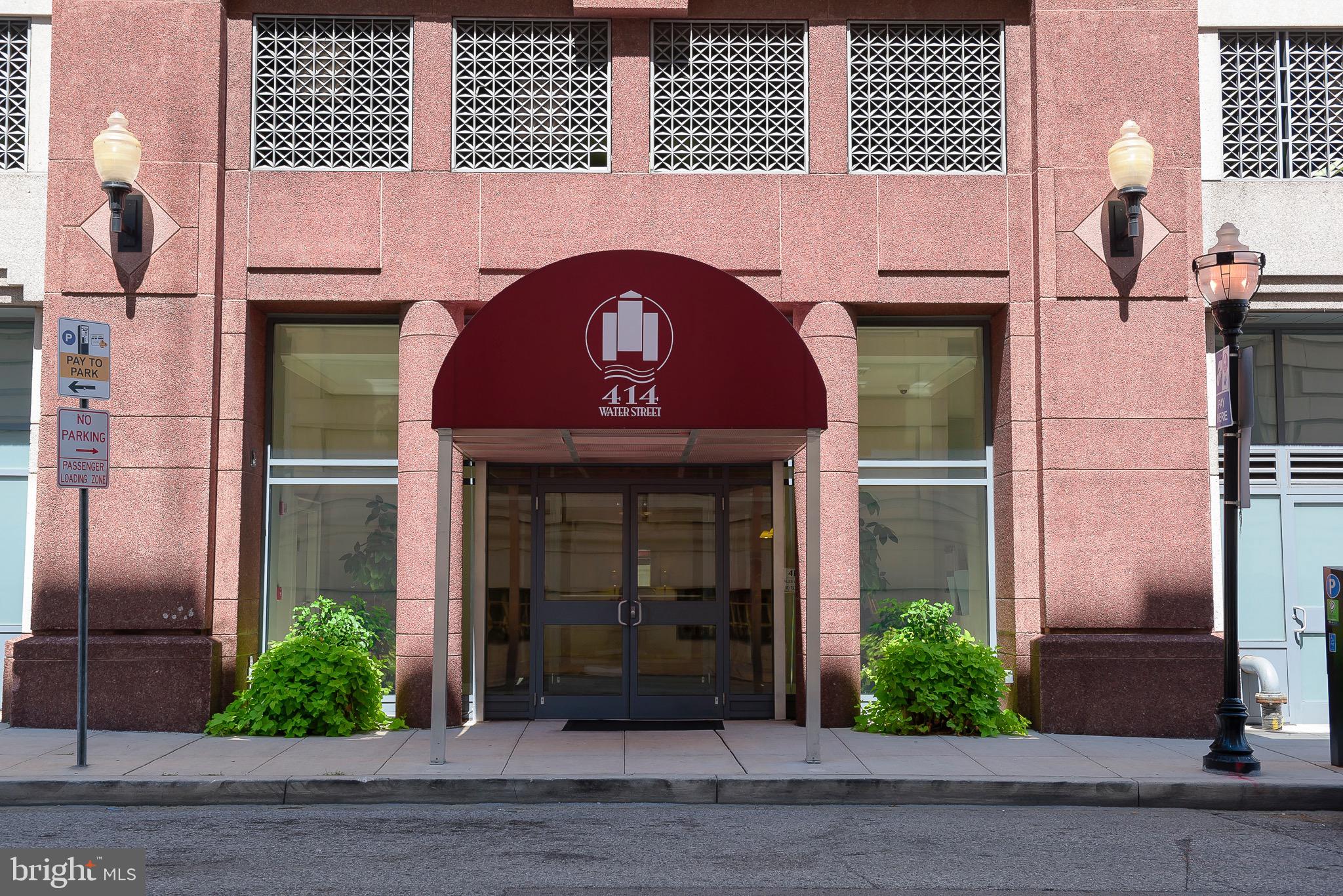 414 Water Street, Unit 1502 Baltimore, MD 21202 - Photo 30 of 32 a front view of a building with garden