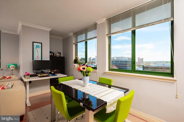 a view of a dining room with a table and chairs