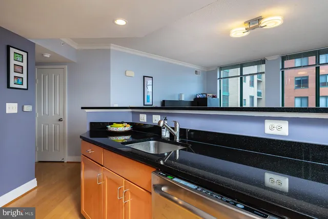 a kitchen with granite countertop a sink and cabinets