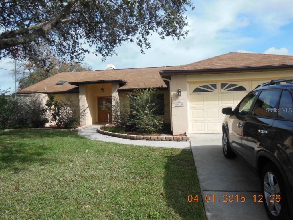 5066 Woodbine Street Spring Hill, FL 34608 - Photo 1 of 1 a view of a car park in front of a house