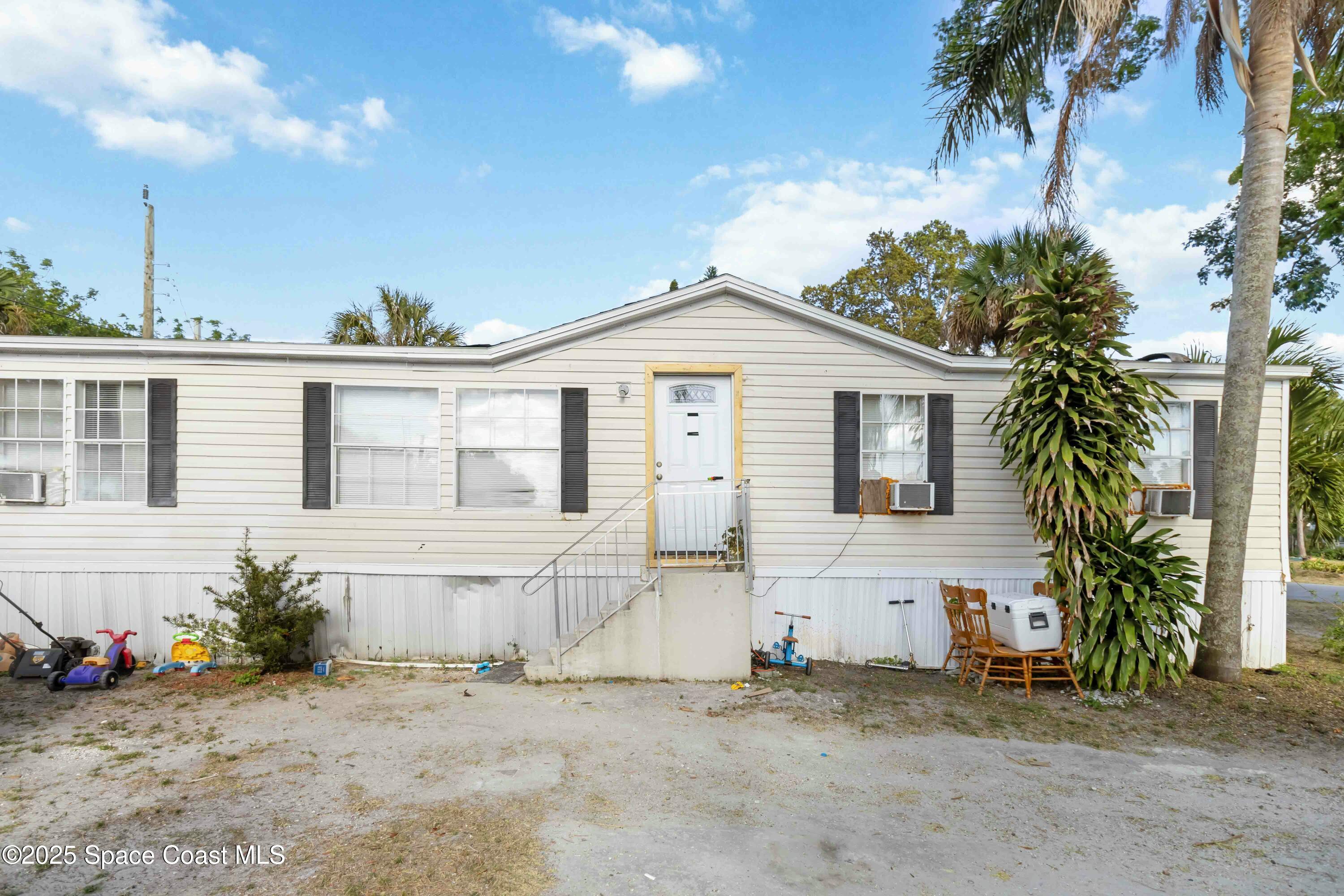 1686 Ackley Road Cocoa, FL 32922 - Photo 2 of 11 a front view of a house with a yard