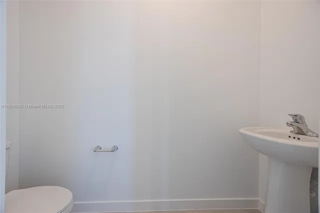 a kitchen with kitchen island white cabinets and refrigerator