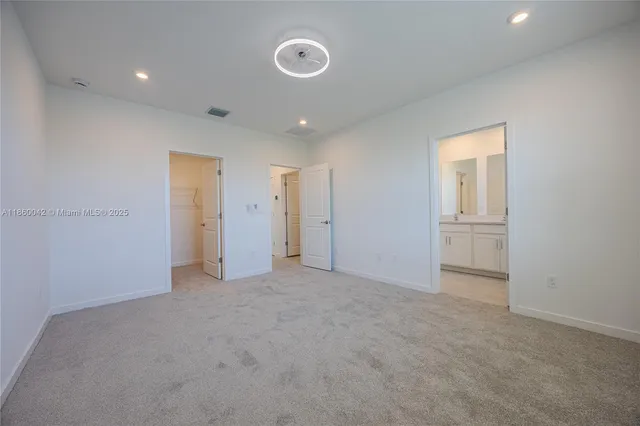 an empty room with windows and closet