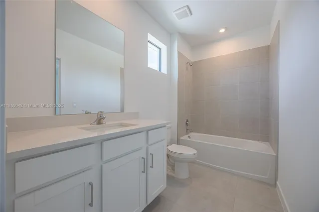a bathroom with a double vanity sink toilet and shower