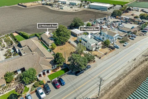 an aerial view of a house a yard and mountain view in back