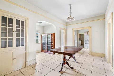 a living room with a table and chairs