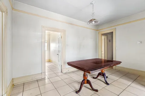 a view of a room with furniture and wooden floor