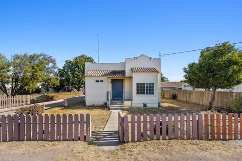 a front view of a house with wooden fence