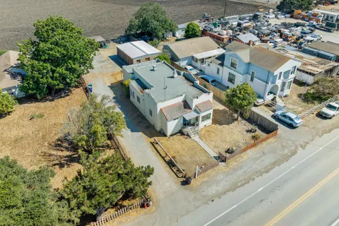 an aerial view of multiple houses with yard