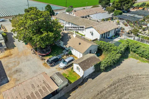 an aerial view of a house with garden space and street view