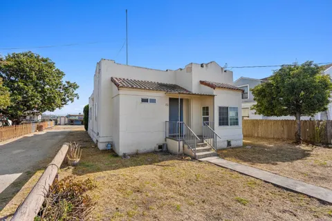 a view of a house with wooden fence
