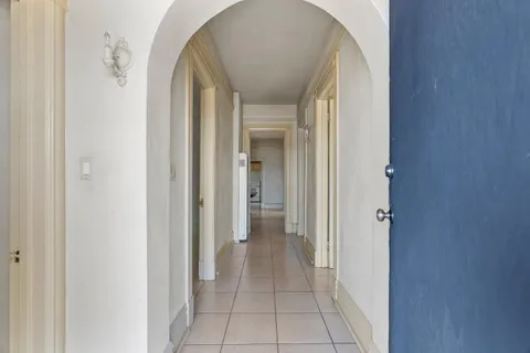 a view of a hallway with wooden shelves
