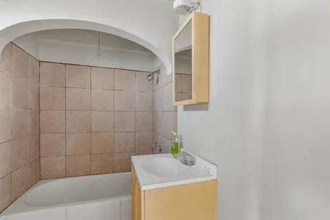 a bathroom with a bathtub and shower