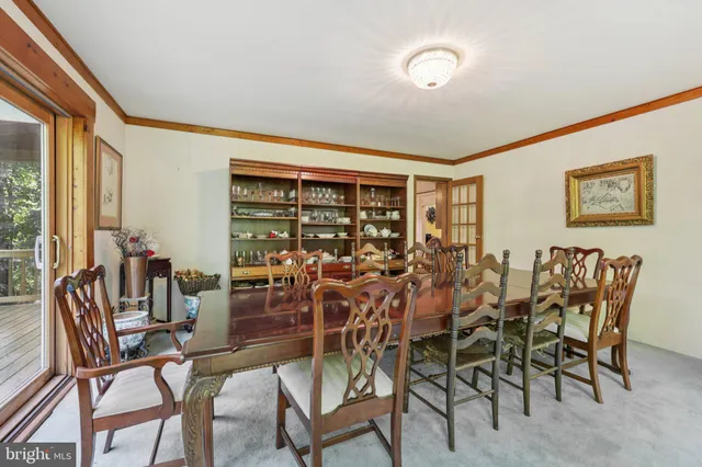 a kitchen with stainless steel appliances granite countertop a stove a sink dishwasher and a dining table with wooden floor