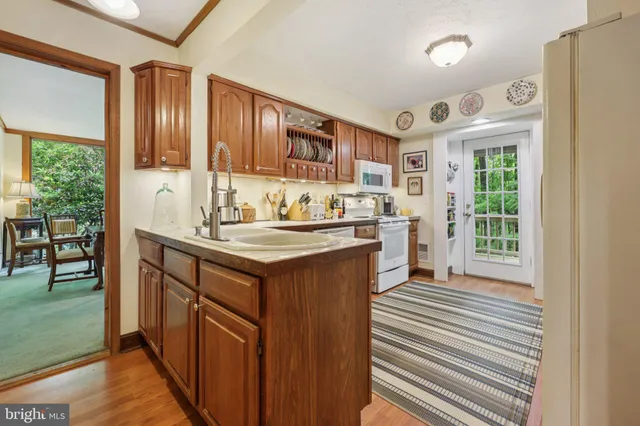 a kitchen with stainless steel appliances a refrigerator and cabinets