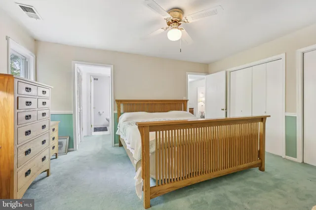 a bedroom with a bed chair and a window