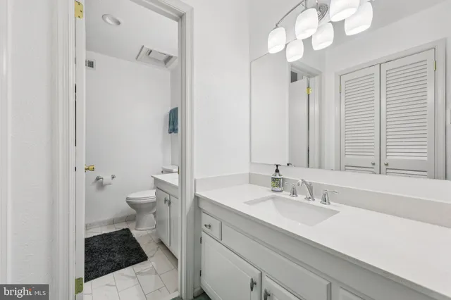a view of room with cabinets and a wooden floor