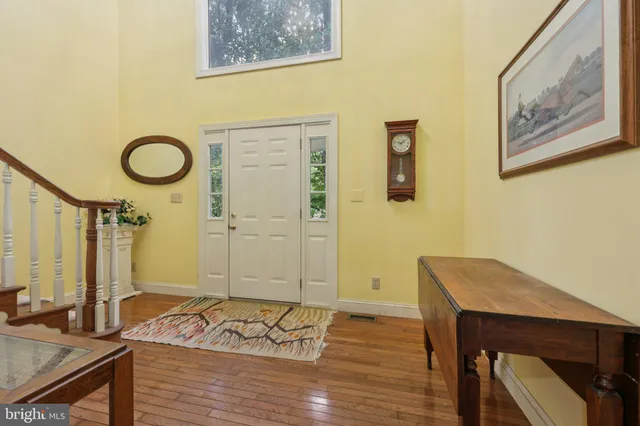 a view of a room with wooden floor and furniture