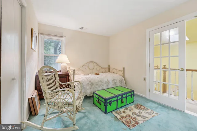 a living room with furniture and a dresser