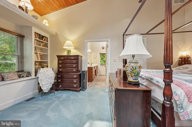 a view of backyard with table and chairs and potted plants