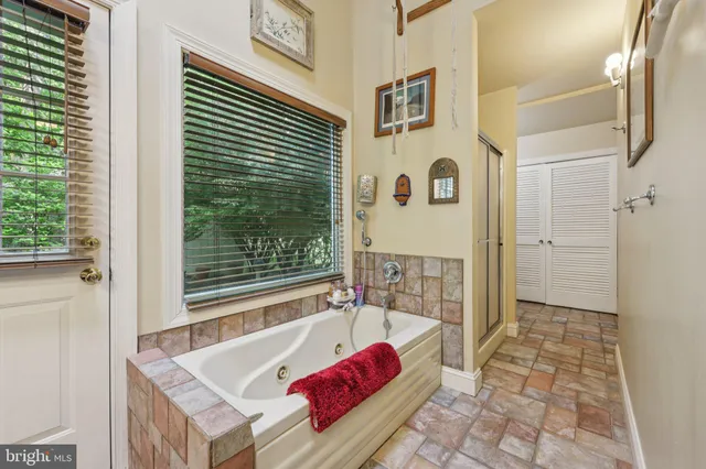 a living room with a black white checkered floor with couches chair and a coffee table