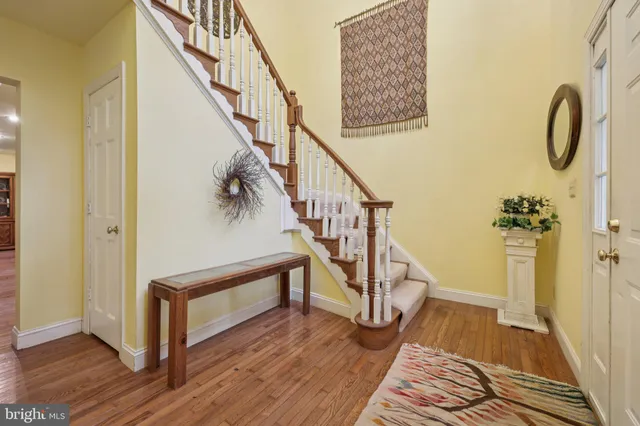 a view of entryway and hall with wooden floor