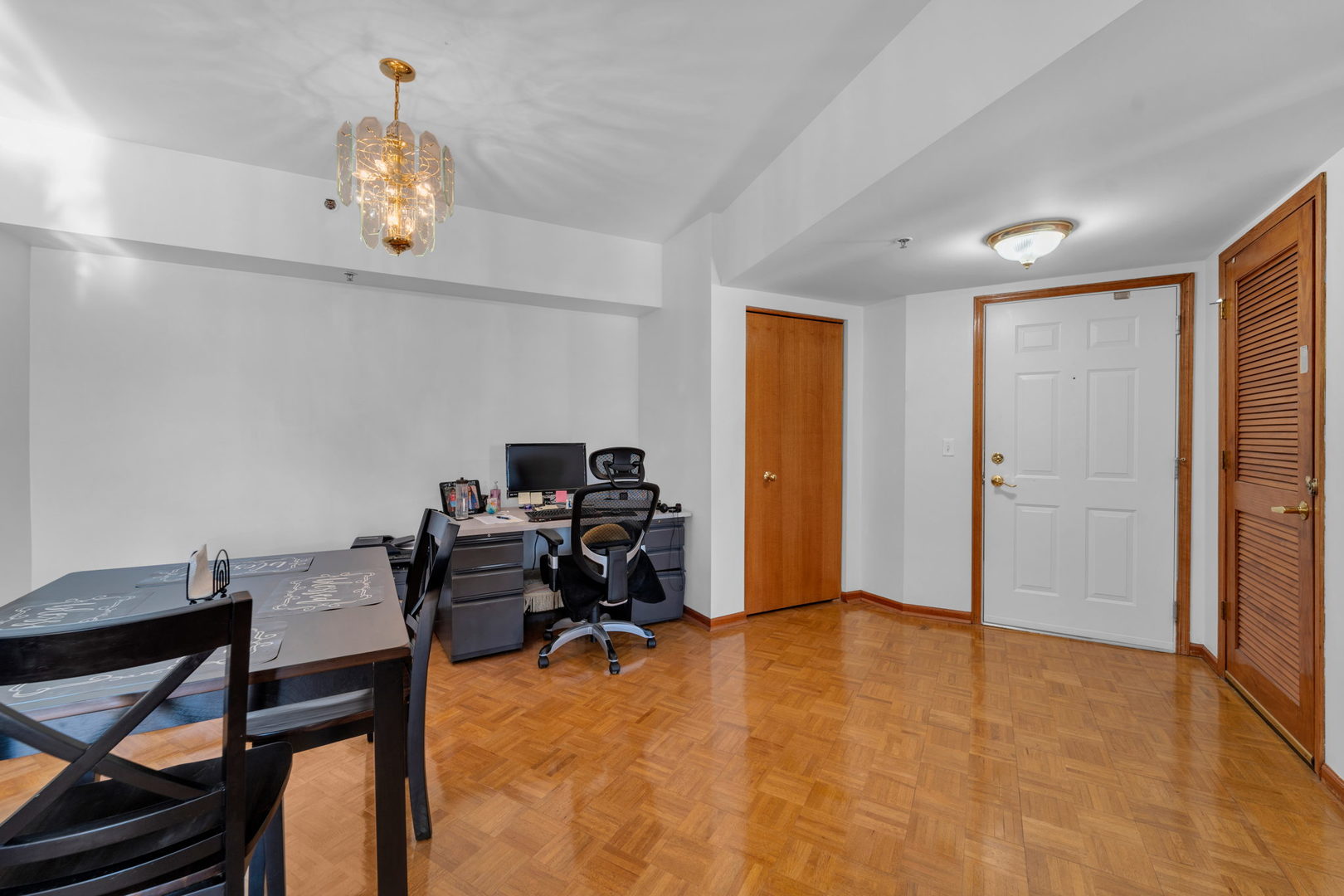 717 North 5th Avenue, Unit 302 Addison, IL 60101 - Photo 3 of 25 a workspace with furniture and chandelier
