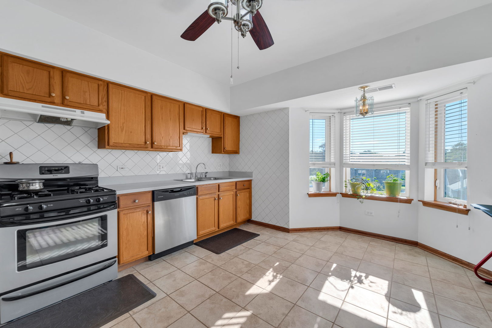 717 North 5th Avenue, Unit 302 Addison, IL 60101 - Photo 4 of 25 a kitchen with a stove a sink and a window