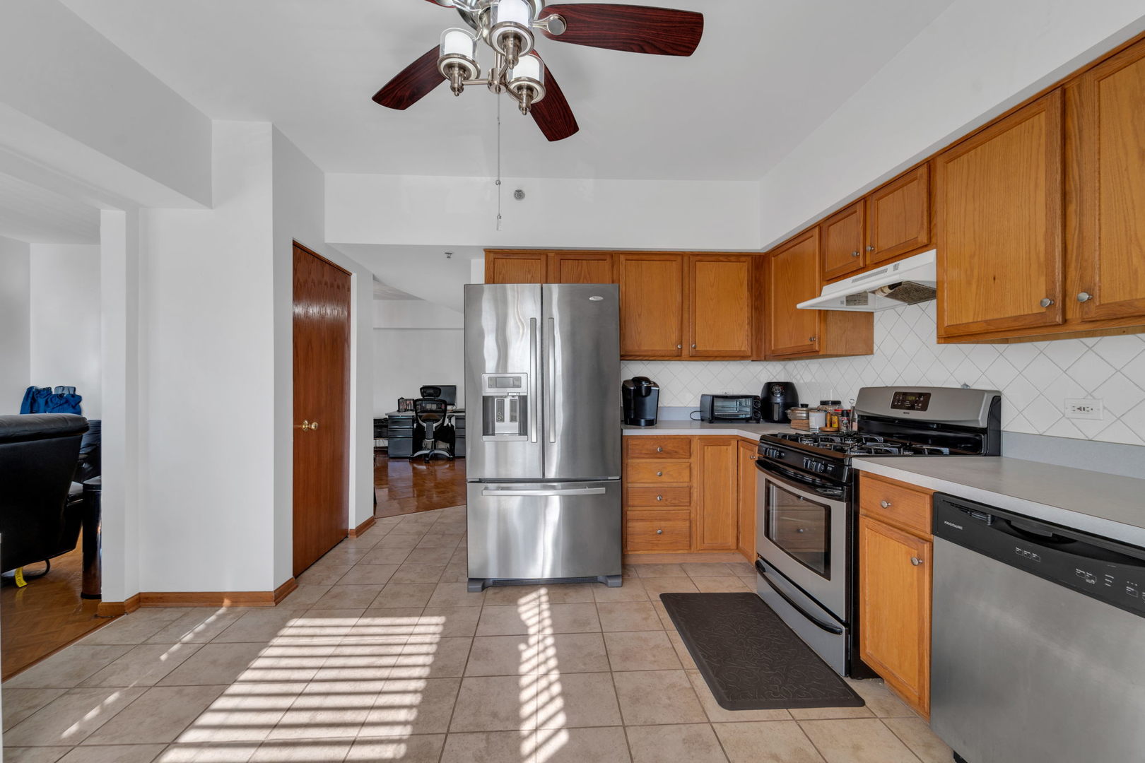 717 North 5th Avenue, Unit 302 Addison, IL 60101 - Photo 6 of 25 a kitchen with stainless steel appliances granite countertop a refrigerator and a stove top oven