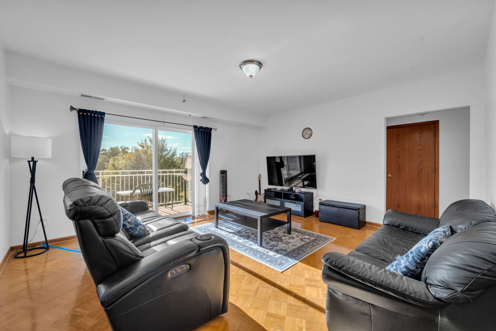 717 North 5th Avenue, Unit 302 Addison, IL 60101 - Photo 7 of 25 a living room with furniture and a flat screen tv