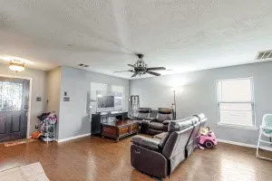 a living room with furniture chess table and a window