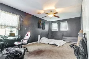 a bedroom with a bed and window