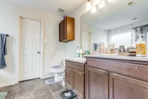 a bathroom with a sink a toilet and mirror