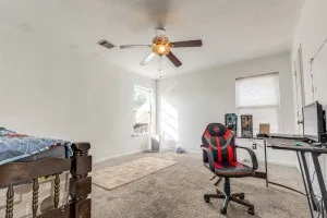 a view of a workspace with furniture and a window