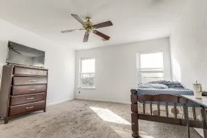 a bedroom with a bed and a window