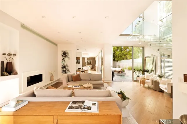 a view of a patio with couches table and chairs and potted plants