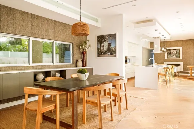 a kitchen with stainless steel appliances kitchen island granite countertop a table and chairs in it