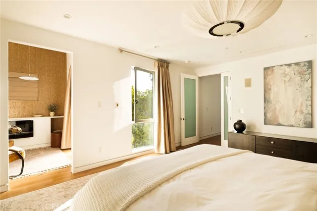 a bedroom with a large bed and a window