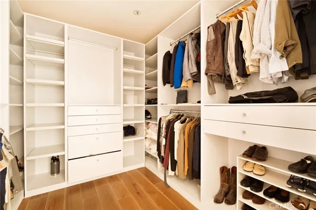 a bedroom with a large bed and a large mirror