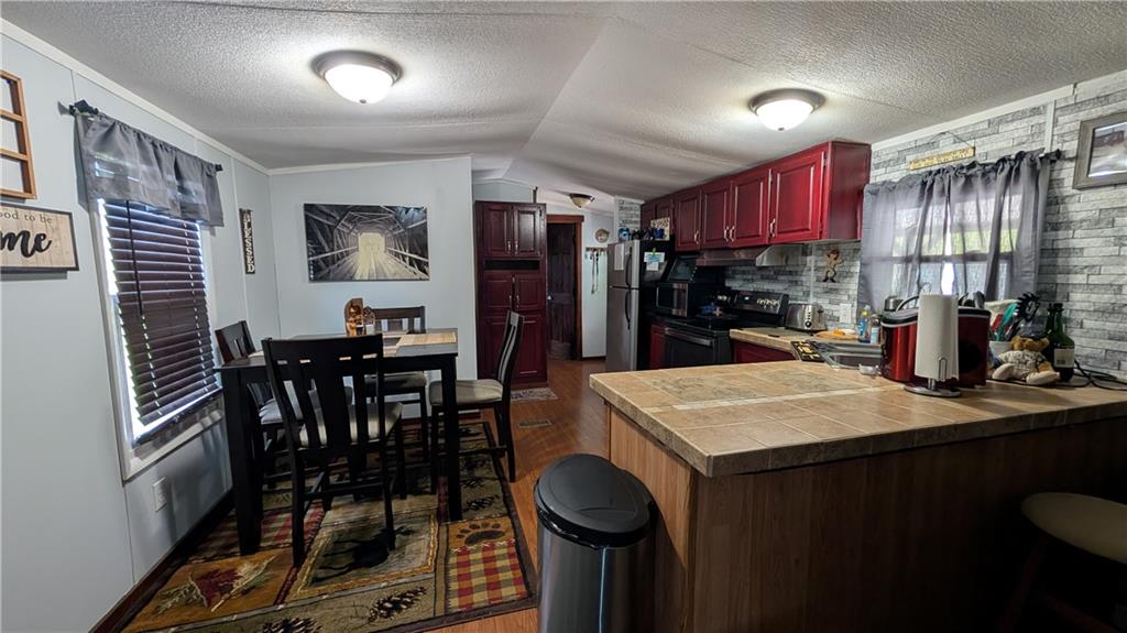 203 Colvin Road Greensboro, PA 15338 - Photo 4 of 20 a kitchen with stainless steel appliances kitchen island granite countertop a table chairs and a refrigerator