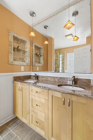a bathroom with a granite countertop sink a mirror and a
