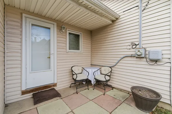 a table and a chair sitting in front of a house