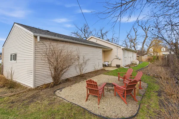 a backyard of a house with table and chairs