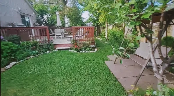 a view of a chair and table in the garden