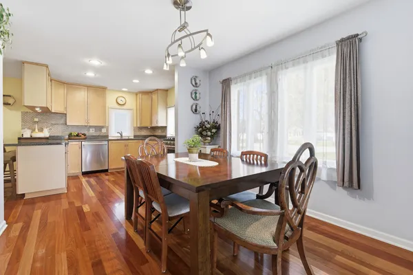 a view of a dining room with furniture and wooden floor