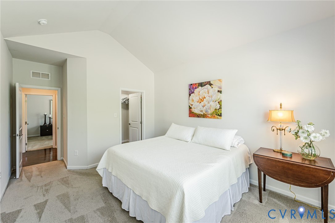 7435 Wicks Road Williamsburg, VA 23188 - Photo 53 of 82 Bedroom 2 featuring vaulted ceilings, light-toned