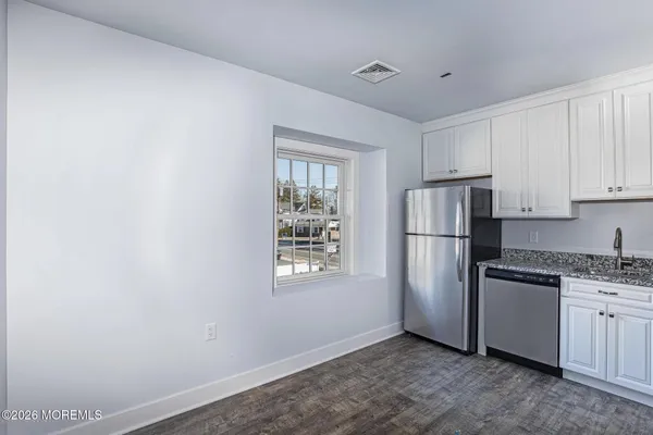 a kitchen with a refrigerator and cabinets