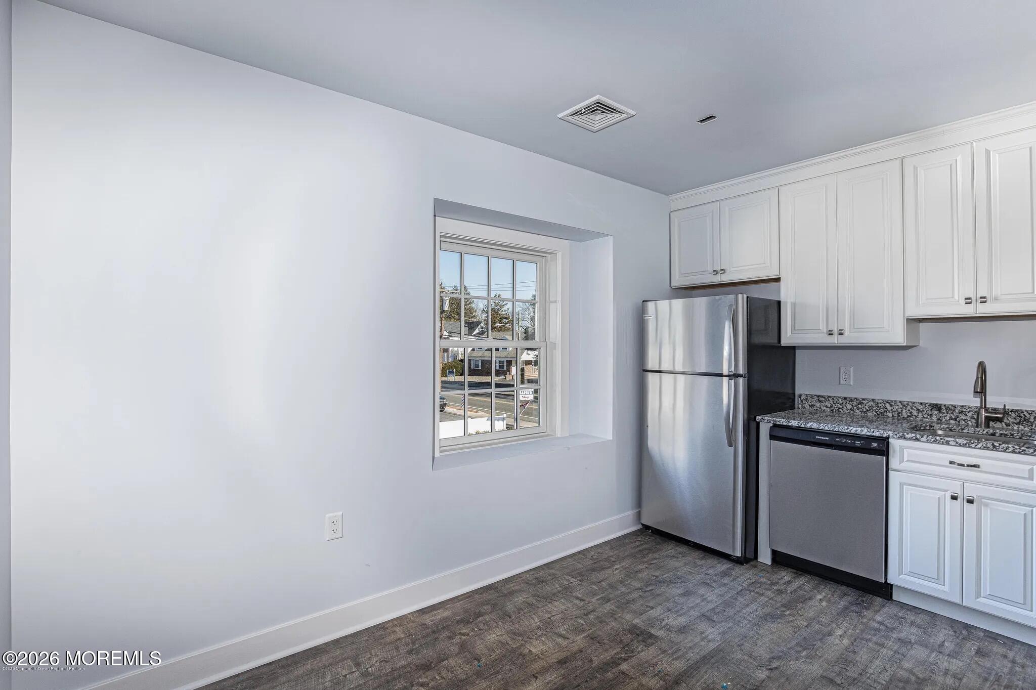 1009 Arnold Avenue, Unit 2A Point Pleasant, NJ 08742 - Photo 2 of 13 a kitchen with a refrigerator and cabinets